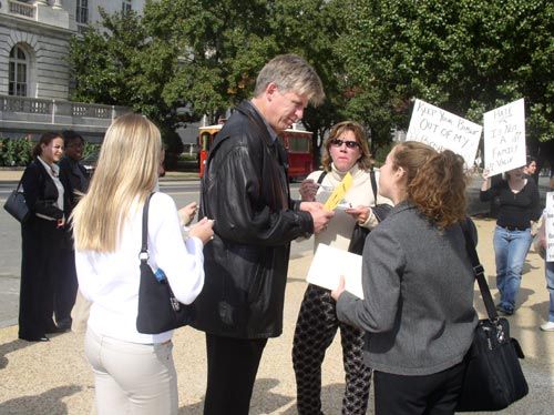 American family eats traditial wedding cake on Capitol Hill while lesbians protest them eating cake chanting "don't eat the cake" to show their opposition to traditional marriage.