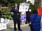 Lesbian bride and groom face crowds with their backs and their name placards on their back to protest PA marriage celebration.