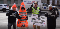 At the Justice Department DOJ protesting the Biden's Mandates and promoting the Defeat the Mandate March by handing out "Wuhan Woke Poke" pens to prolife marchers.