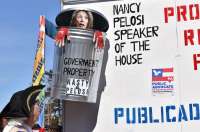 NANCY PELOSI SPEAKER OF THE HOUSE IS DISPLAYED AS COMING OUT OF A GIANT GARBAGE CAN MARKED "GOVERNMENT PROPERTY" on our trailer for the Truckers Convoy for Religious Freedom. 